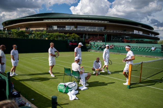 Andy Murray, seated, and Roger Federer, right, practised together at Wimbledon on Friday
