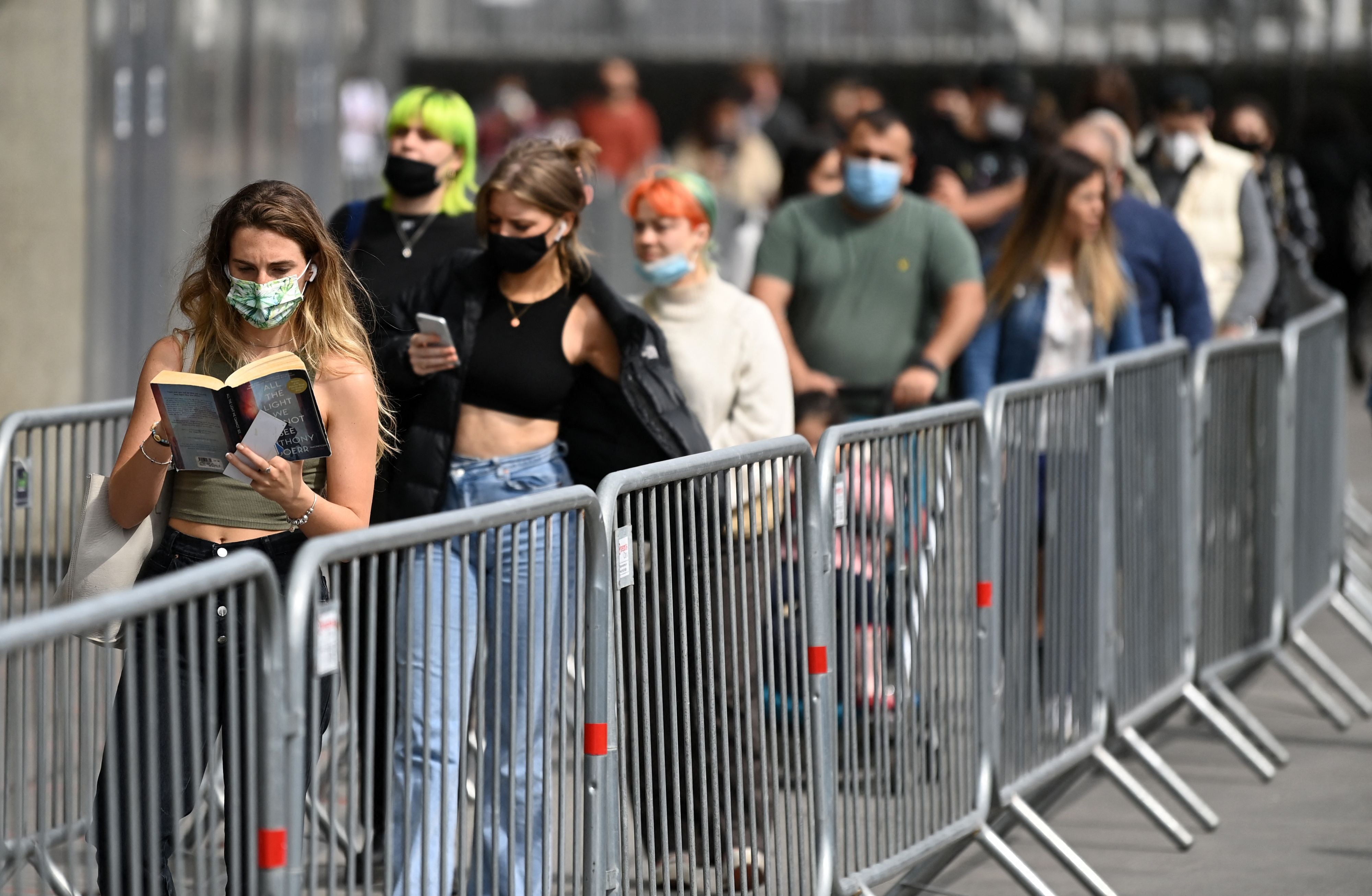 <p>Members of the public queue to receive a Covid-19 vaccine at the Emirates Stadium in north London</p>