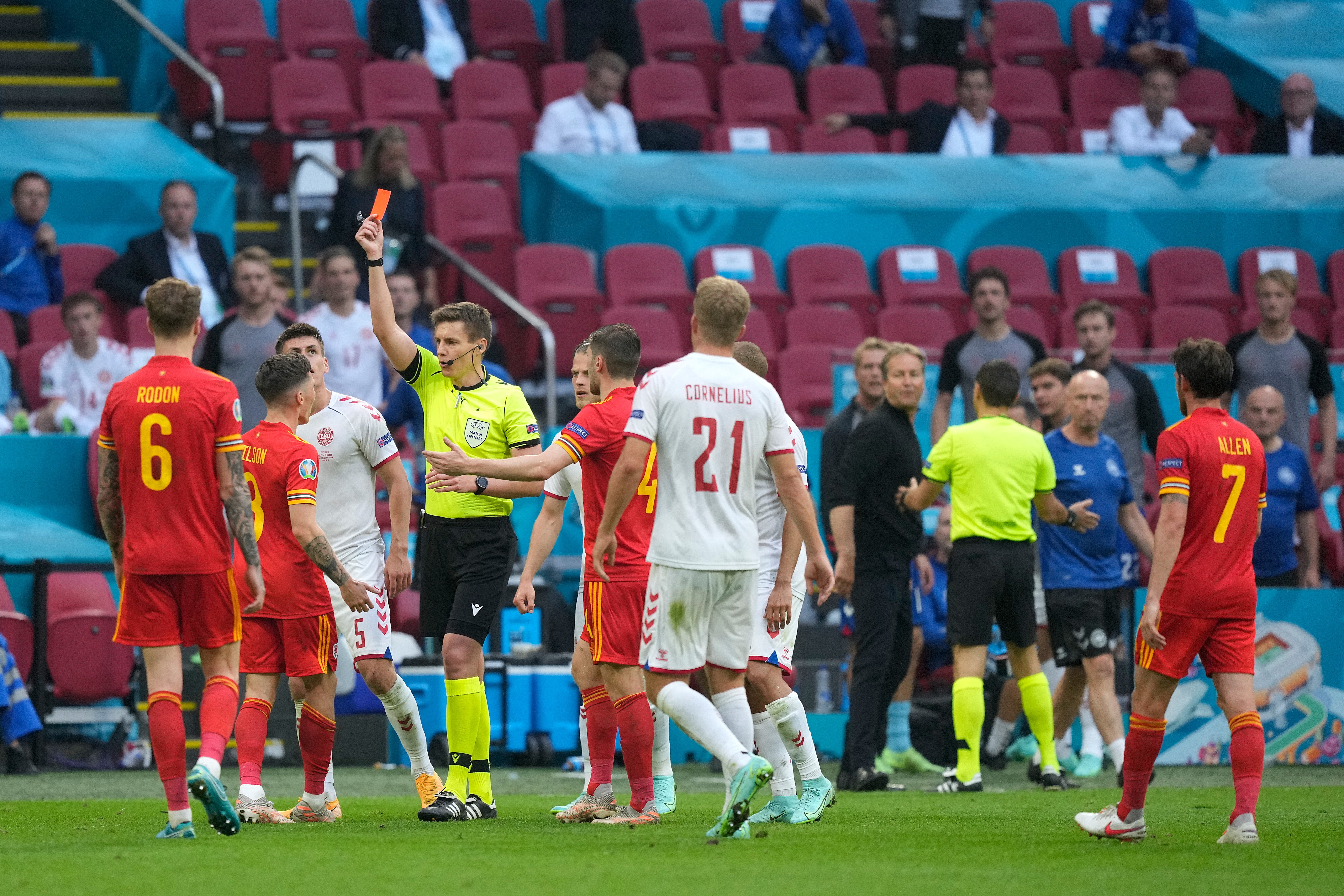 Harry Wilson of Wales is shown a red card