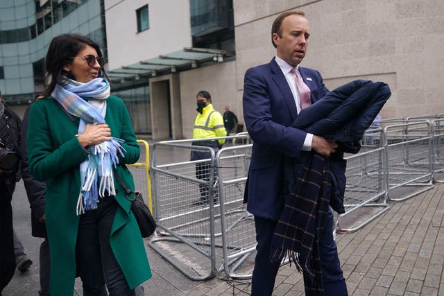 <p>Getting their coats: Gina Coladangelo pictured with Matt Hancock last month</p>