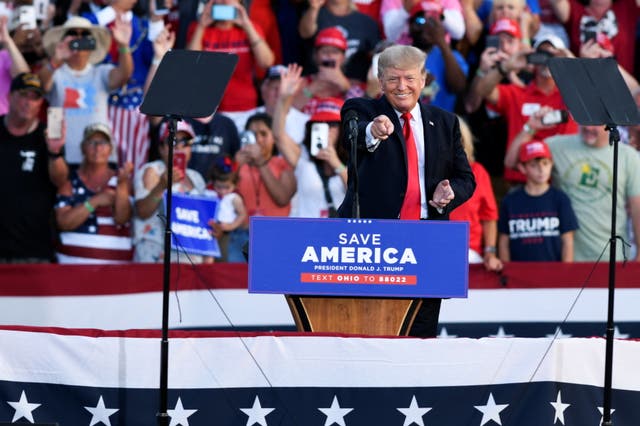<p>Former U.S. President Trump gestures as he smiles during first post-presidency campaign rally at the Lorain County Fairgrounds in Wellington, Ohio</p>