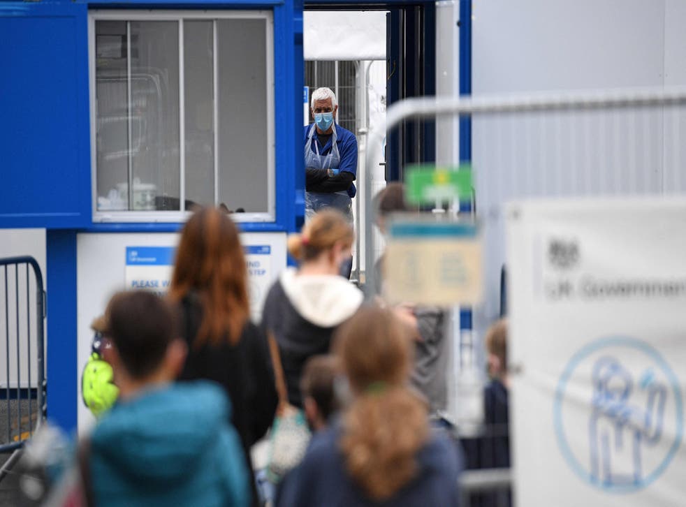 <p>Members of the public at a Covid testing centre in Cumbria, UK</p>
