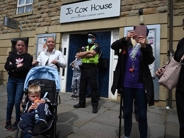 <p>A police officer keeps watch outside Jo Cox House in Batley, West Yorkshire</p>