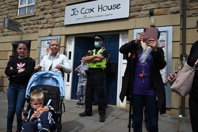 <p>A police officer keeps watch outside Jo Cox House in Batley, West Yorkshire</p>