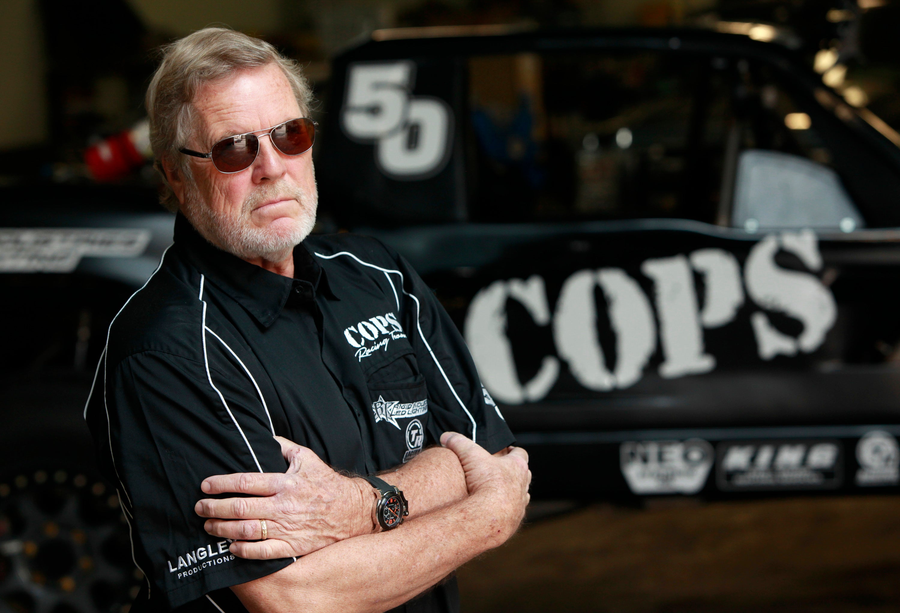 SCORE International CEO Saul Fish (not pictured) gives Cops Racing Team owner (and former Baja 1000 winner) John Langley a preview of the watch at Cops Racing on 1 November, 2012 in El Segundo, California