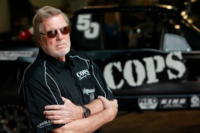 <p>SCORE International CEO Saul Fish (not pictured) gives Cops Racing Team owner (and former Baja 1000 winner) John Langley a preview of the watch at Cops Racing on 1 November, 2012 in El Segundo, California</p>