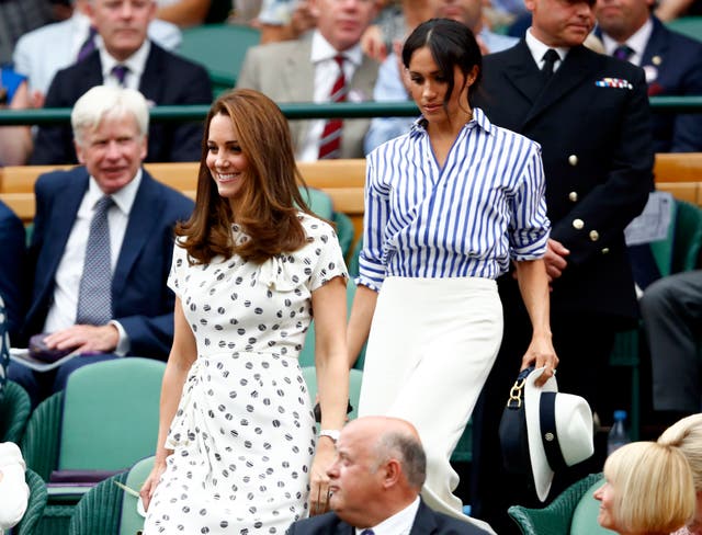 The Duchess of Cambridge and the Duchess of Sussex in the royal box on centre court on day twelve of Wimbledon 2018