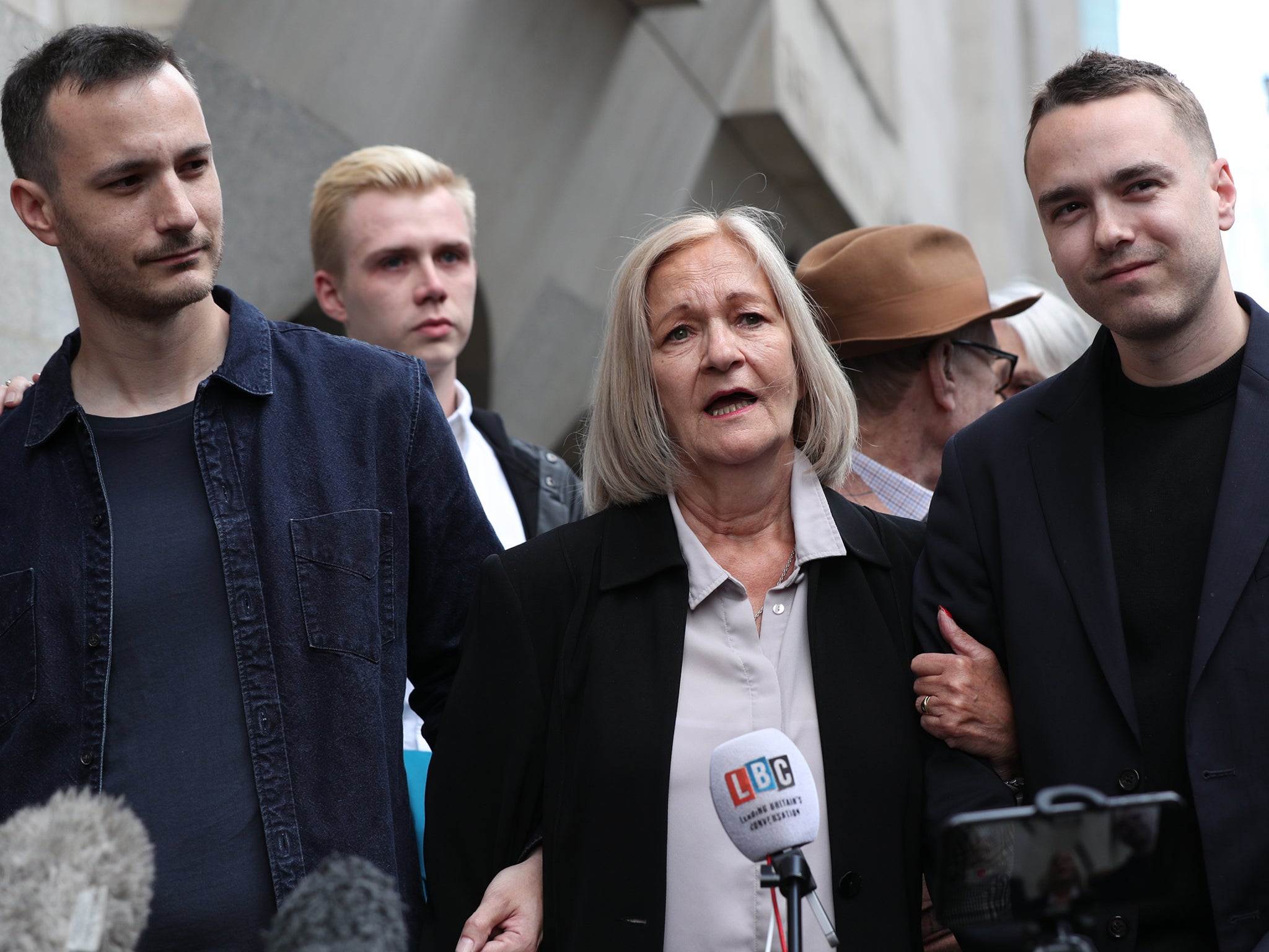 Sally Challen, flanked by her sons James (left) and David, leaves the Old Bailey after hearing she will not face a retrial over the death of her husband Richard in 2010