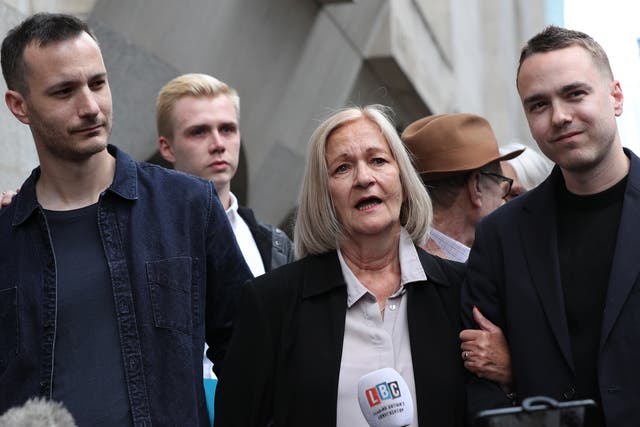 <p>Sally Challen, flanked by her sons James (left) and David, leaves the Old Bailey after hearing she will not face a retrial over the death of her husband Richard  in 2010</p>