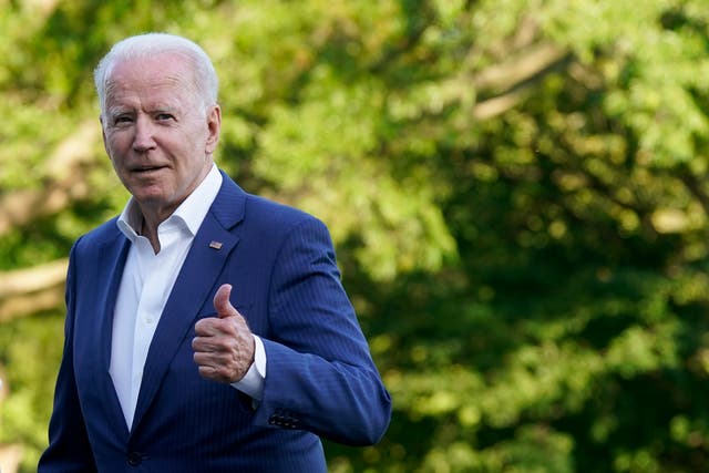 <p>President Joe Biden gestures as he walks on the South Lawn of the White House on Sunday</p>