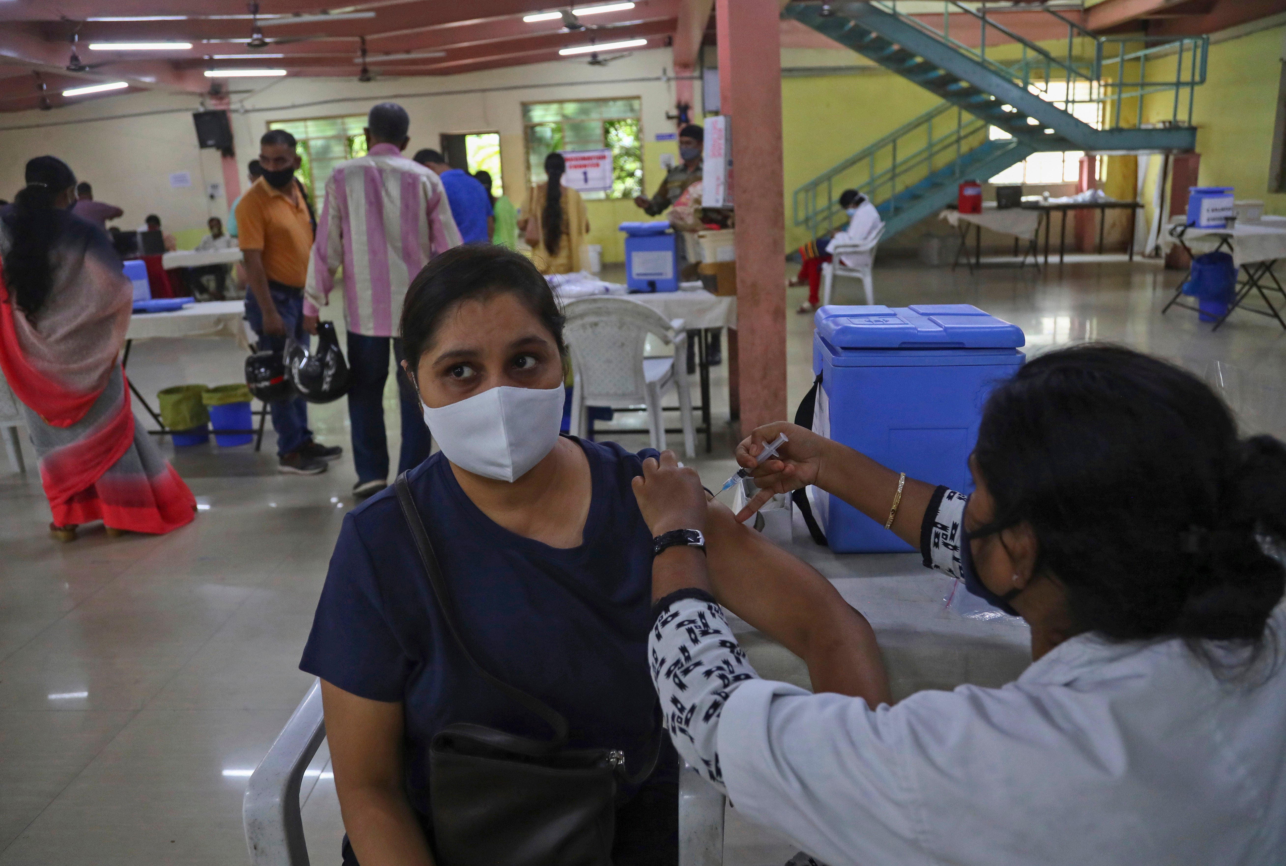 A health worker administers the Covishield vaccine to a woman in India’s Hyderabad on 23 June, 2021