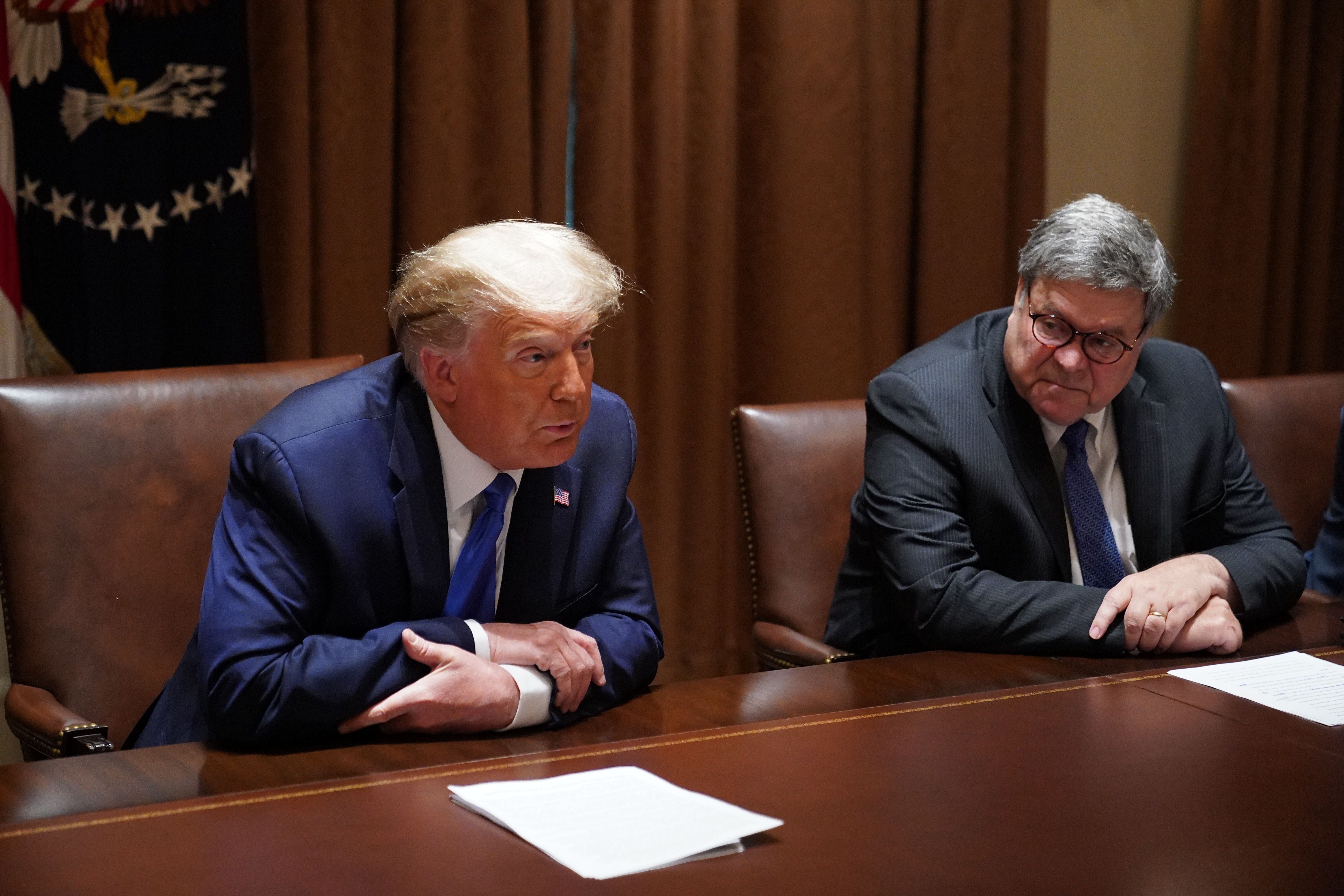 Then-President Donald Trump, with then-Attorney General William Barr ,speaks during a discussion with state attorneys general on protection from social media abuses in the Cabinet Room of the White House in Washington, DC, on 23 September, 2020. Mr Trump has lashed out at Mr Barr after a report he called the ex-president’s claims of election fraud in the 2020 election ‘bulls***’.