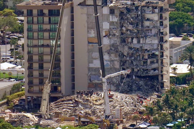 <p>This aerial image shows an oceanfront condo building that partially collapsed three days earlier, resulting in fatalities and many people still unaccounted for, in Surfside, Florida on 27 June 2021</p>