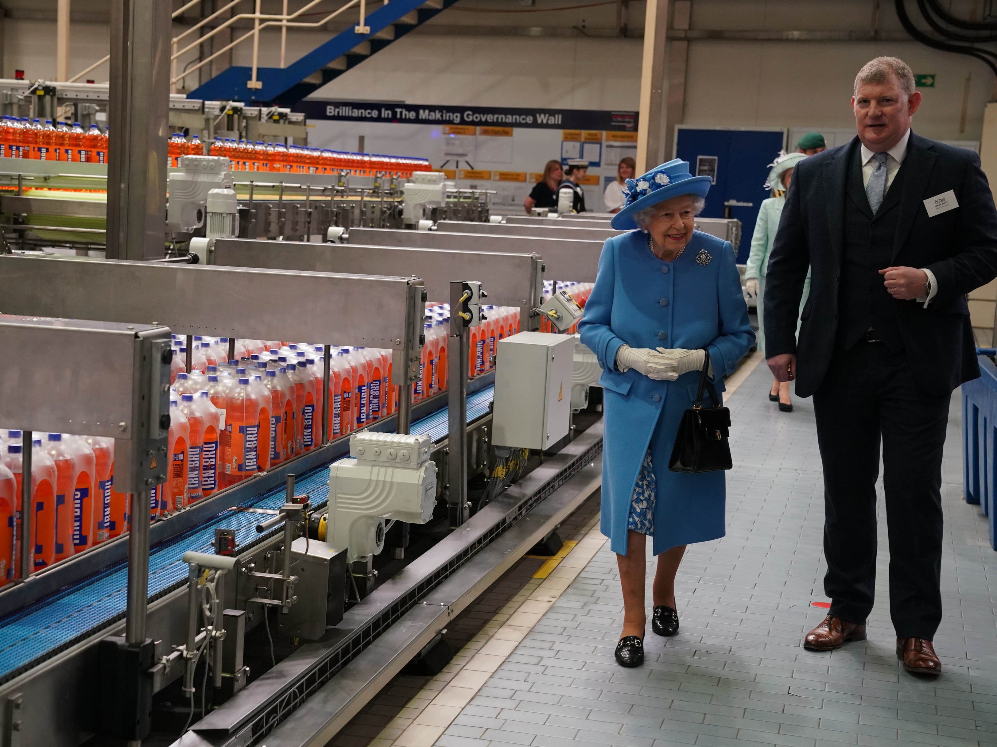 <p>Queen Elizabeth II during a visit to AG Barr's factory in Cumbernauld, where the Irn-Bru drink is manufactured, as part of her traditional trip to Scotland for Holyrood Week</p>