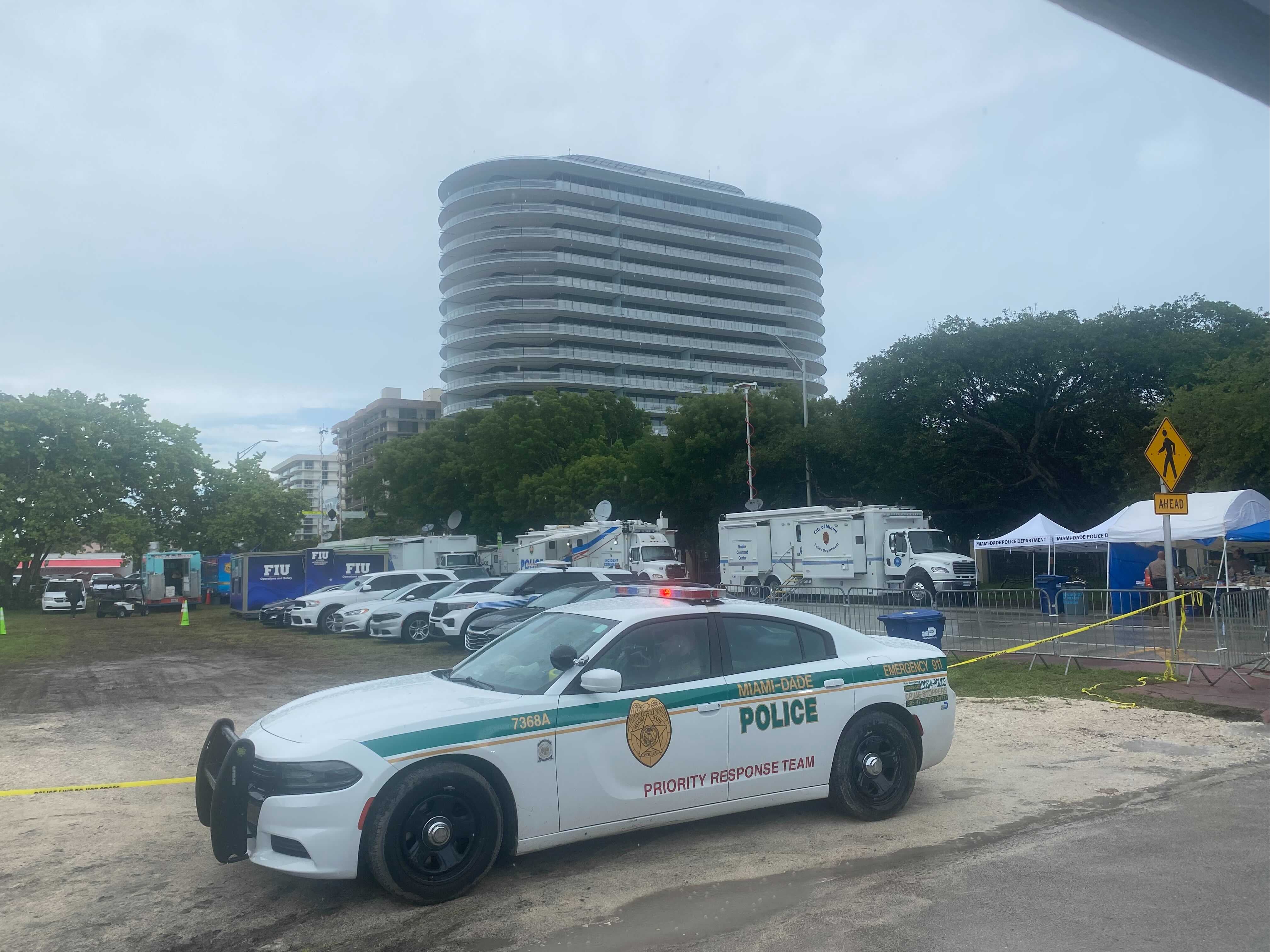 A police vehicle can be seen near the site of the building collapse in Surfside, Florida.