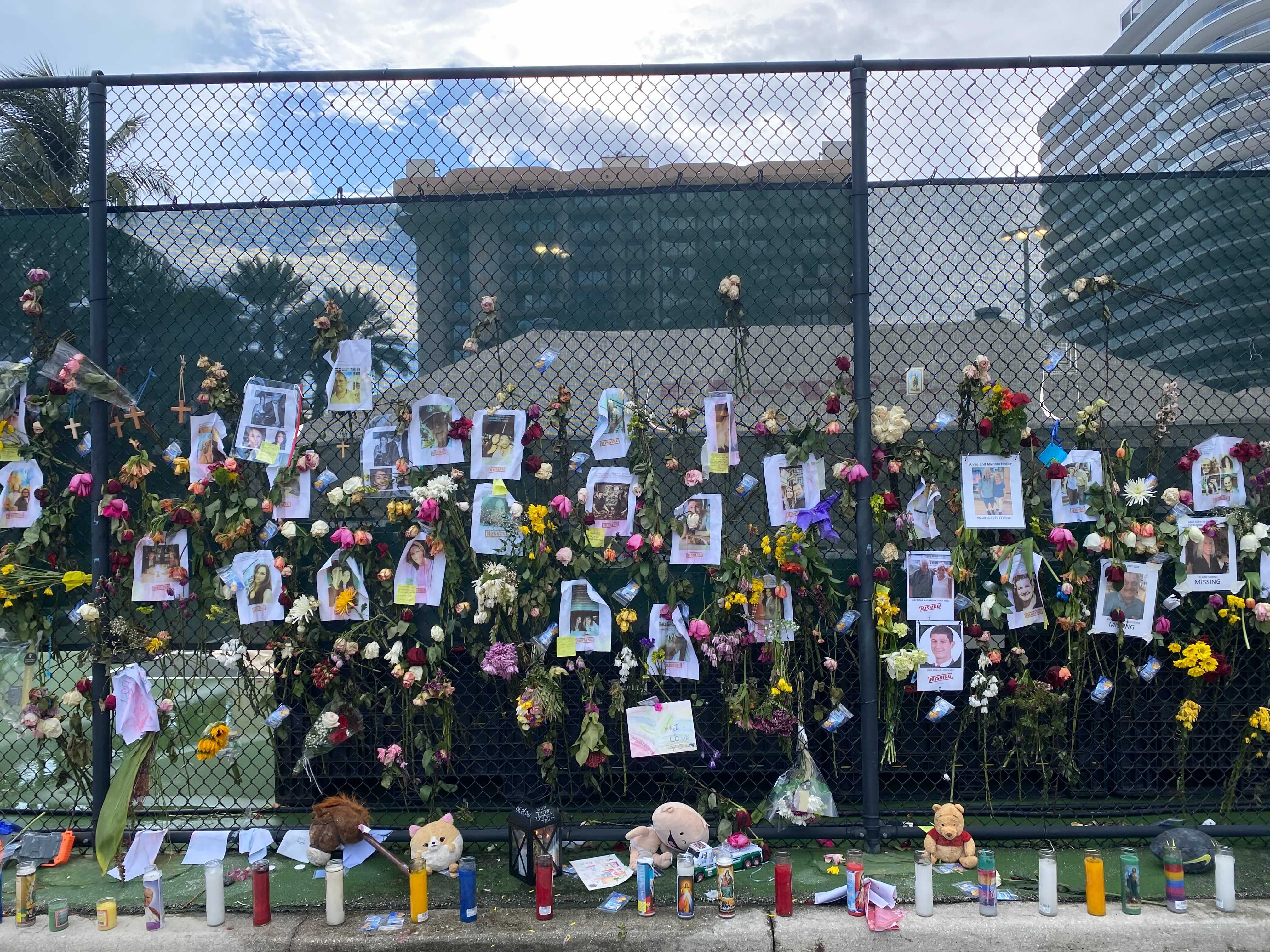 Tributes to victims and missing people line a street in Surfside, Florida.