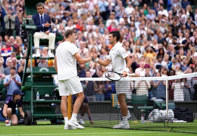 Jack Draper (left) shakes hands with Novak Djokovic