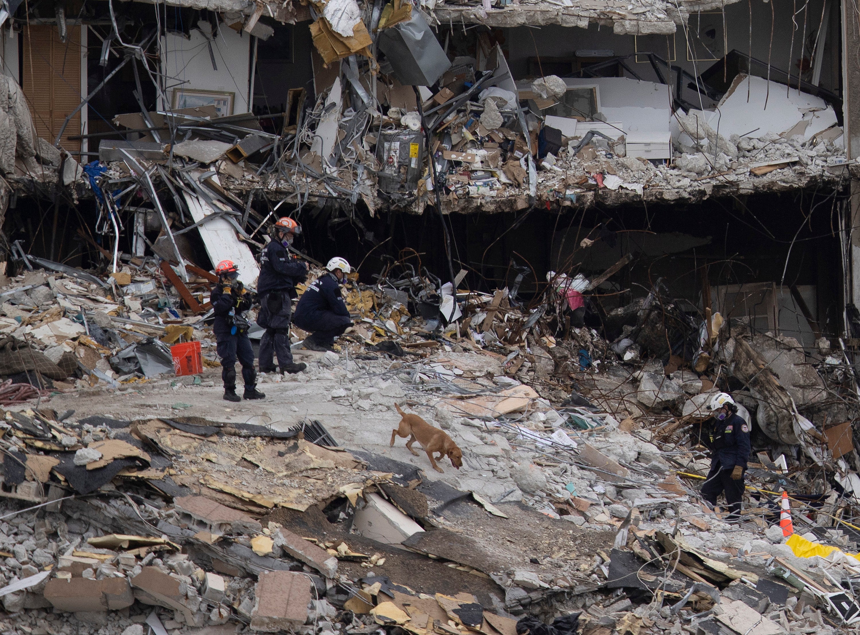 Search and Rescue teams look for possible survivors and to recover remains in the partially collapsed 12-story Champlain Towers South condo building on June 28, 2021