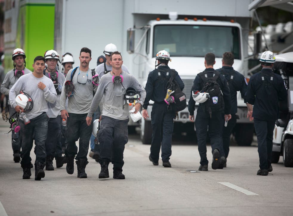 <p>Search and rescue crews from the Jacksonville Fire Dept and members of Florida Task Force 5 walk out of the work area as another crew heads in</p>