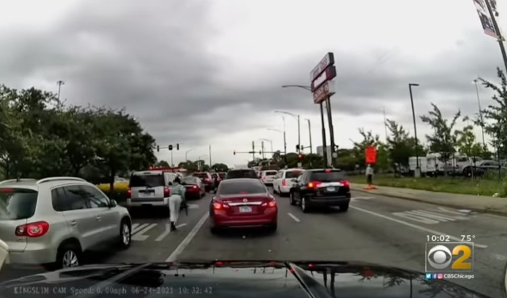 Chicago police release footage of gunman with automatic weapon opening fire at traffic light