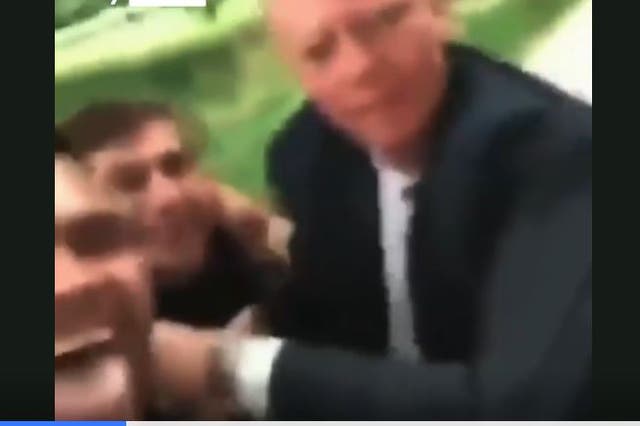 <p>Prof Chris Whitty is seen being grabbed by two men</p>