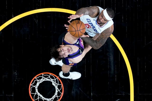 Los Angeles Clippers center DeMarcus Cousins (15) shoots over Phoenix Suns forward Dario Saric