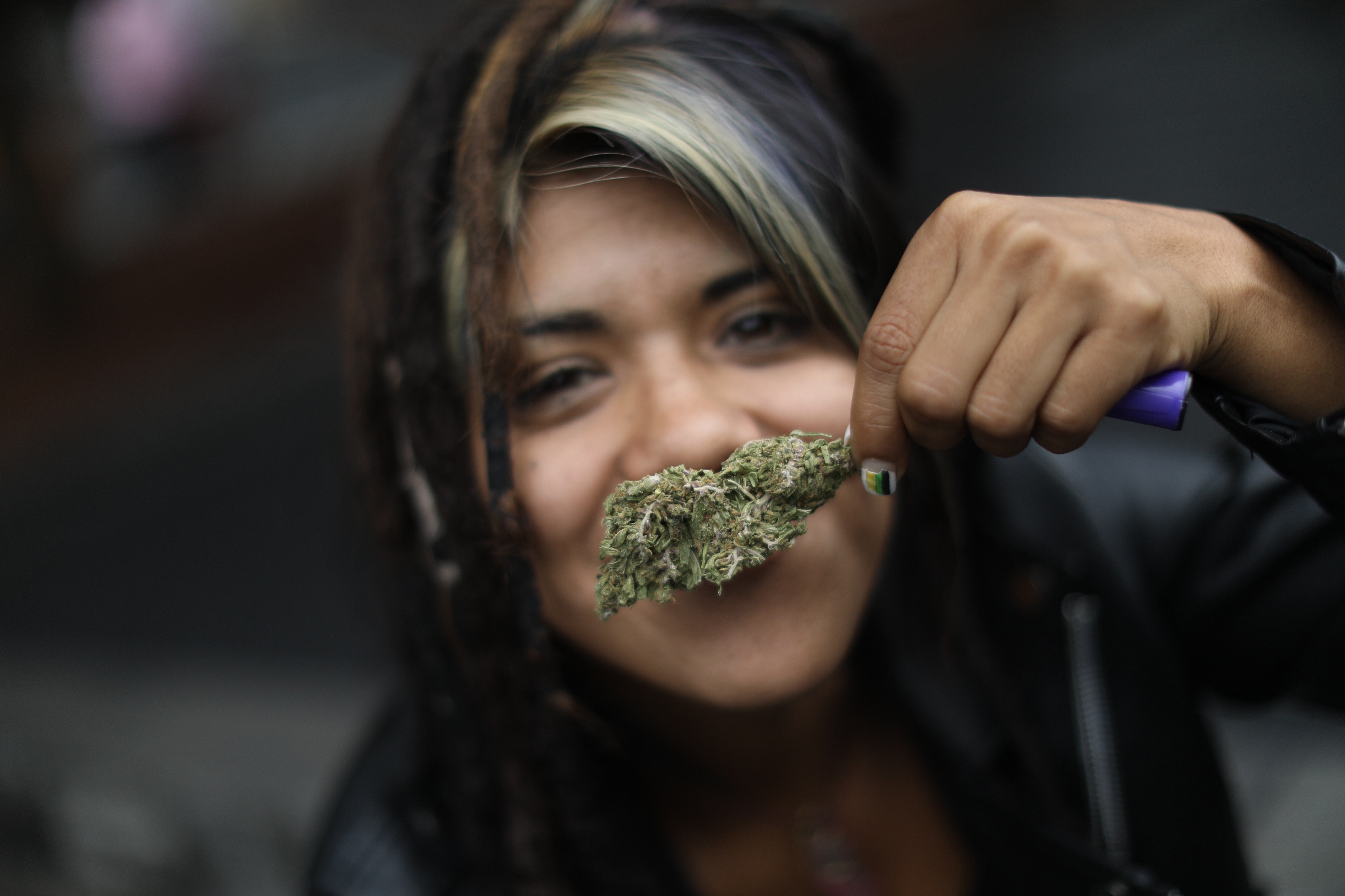 A woman shows a marijuana bud during a sit-in organised by the Mexican Cannabis Movement ‘Planton 420’ outside the Supreme Court of Justice of the Nation (SCJN), in Mexico City, Mexico, 28 June 2021