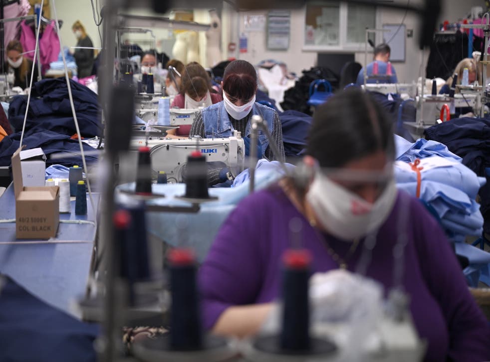 <p>Workers make scrubs for the NHS at a factory in north London. Low-paid jobs have become harder to fill since EU recruitment dried up post Brexit</p>