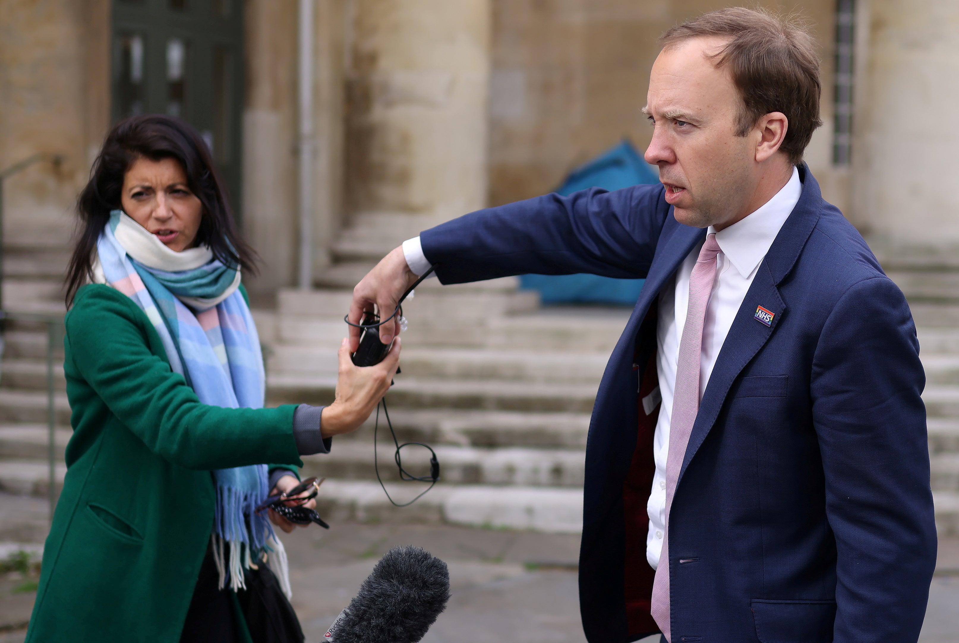 Matt Hancock hands a microphone to his aide Gina Coladangelo outside Broadcasting House in May