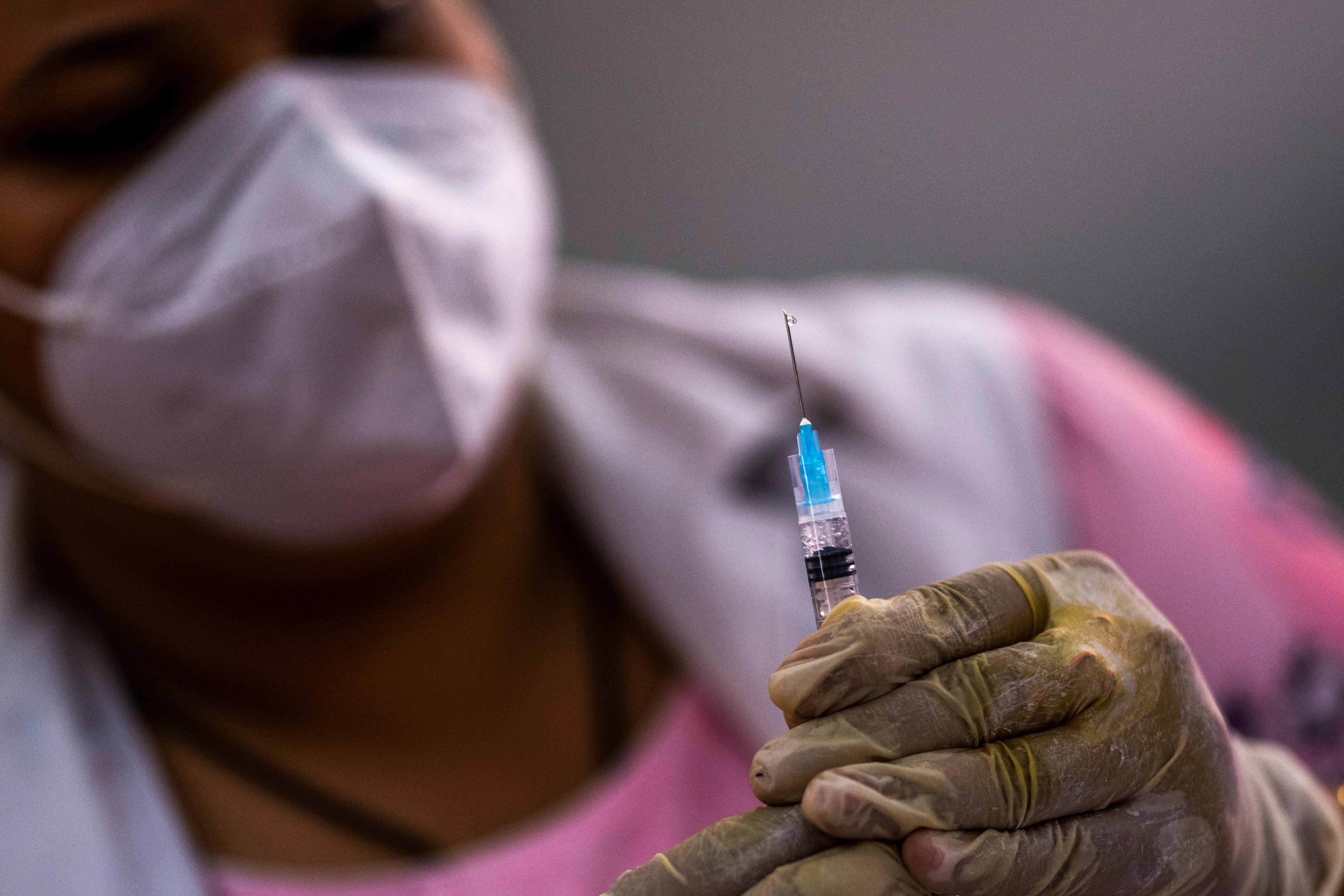 File: A health worker prepares to inoculate with a dose of a Covid-19 vaccine in Delhi on 3 May, 2021