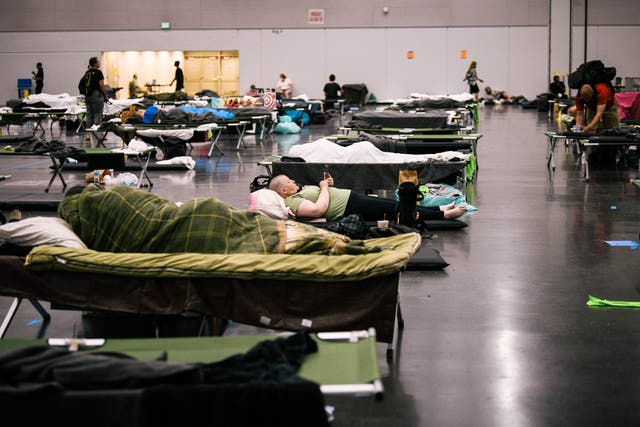 <p>People rest at the Oregon Convention Center cooling station in Oregon, Portland on June 28, 2021, as a heatwave moves over much of the United States</p>
