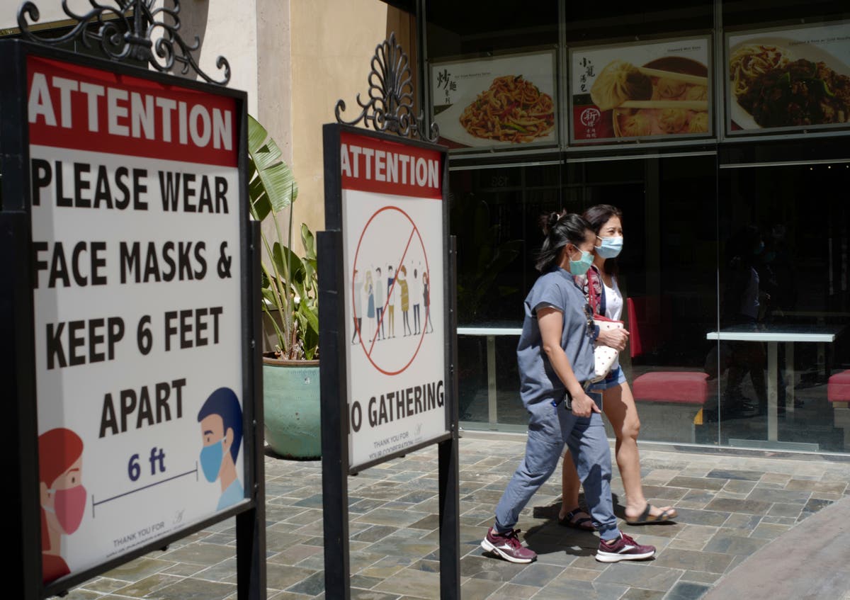 The county of Los Angeles has reissued a recommendation for wearing masks indoors, regardless of vaccination status, as public health officials clash 