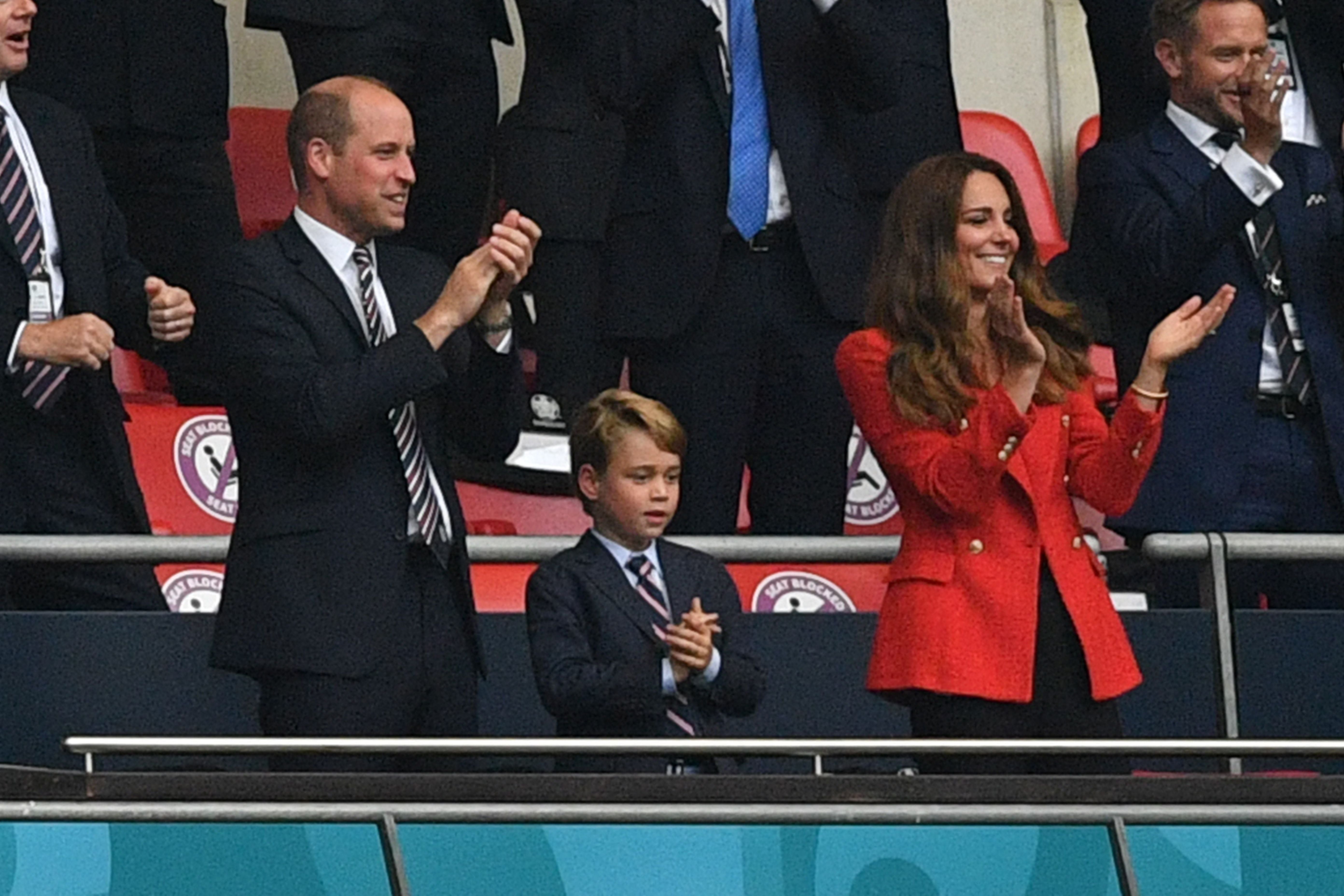 Prince William, Duke of Cambridge, Prince George of Cambridge, and Catherine, Duchess of Cambridge, celebrate the first goal