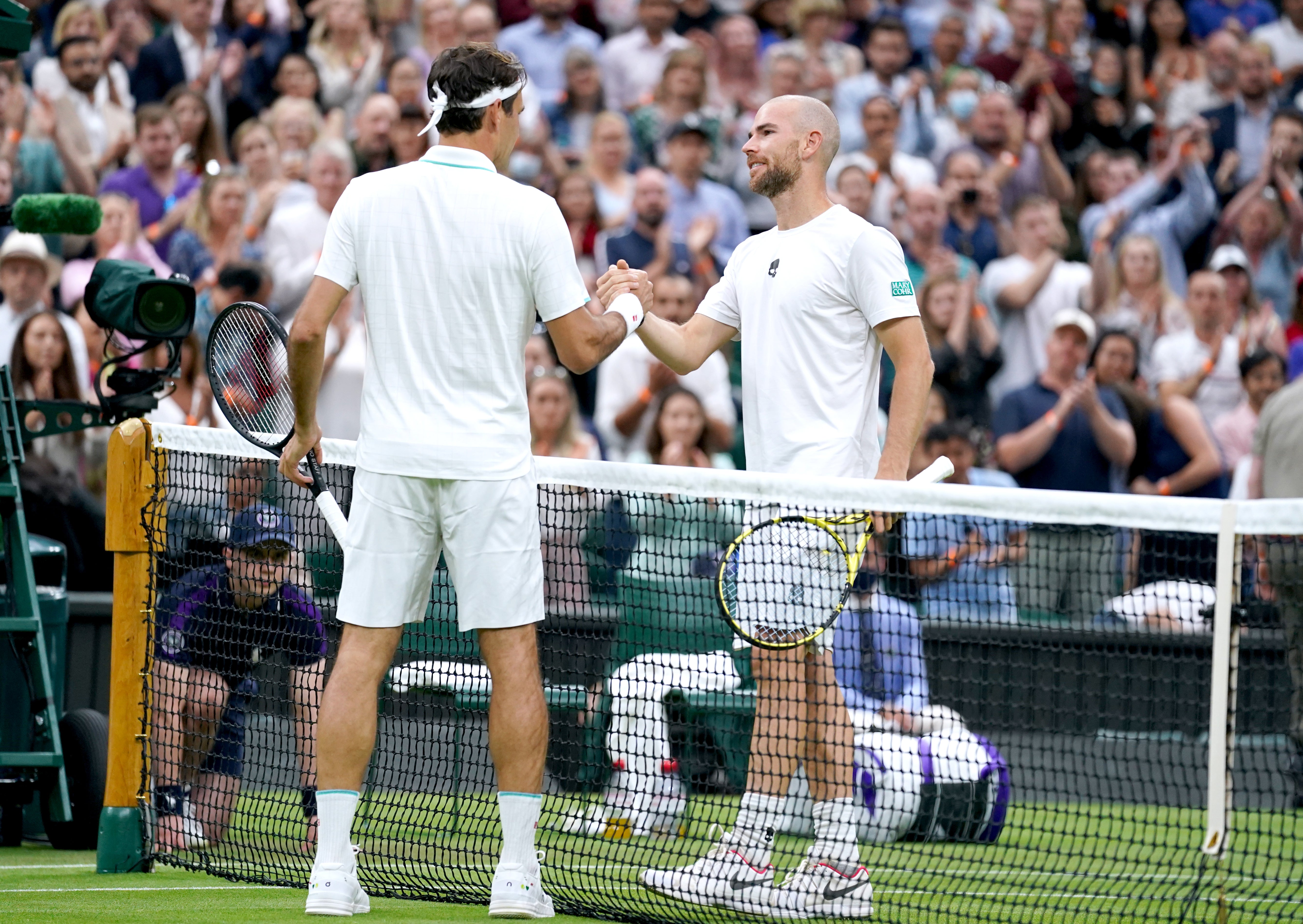 Roger Federer, left, was pushed all the way by Adrian Mannarino
