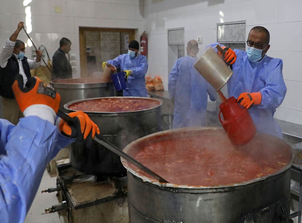 <p>FILE photo: Workers prepare and serve soup for people in need at the Takeyat Ibrahim kitchen in Hebron's Old City in West Bank on 15 April, 2021</p>