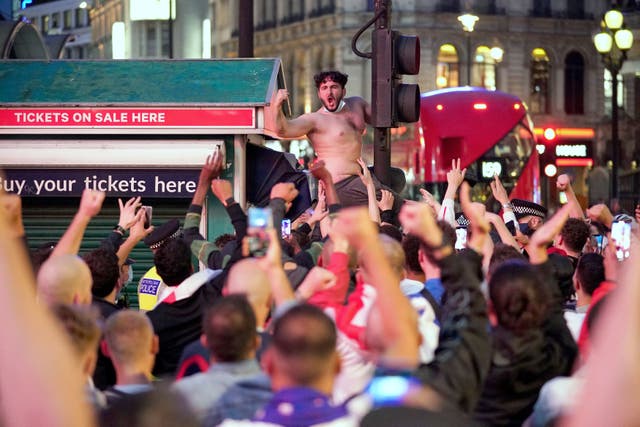 <p>England football fans in Piccadilly Circus, central London, celebrating England's victory over Germany in the Euro 2020 round of 16 match</p>