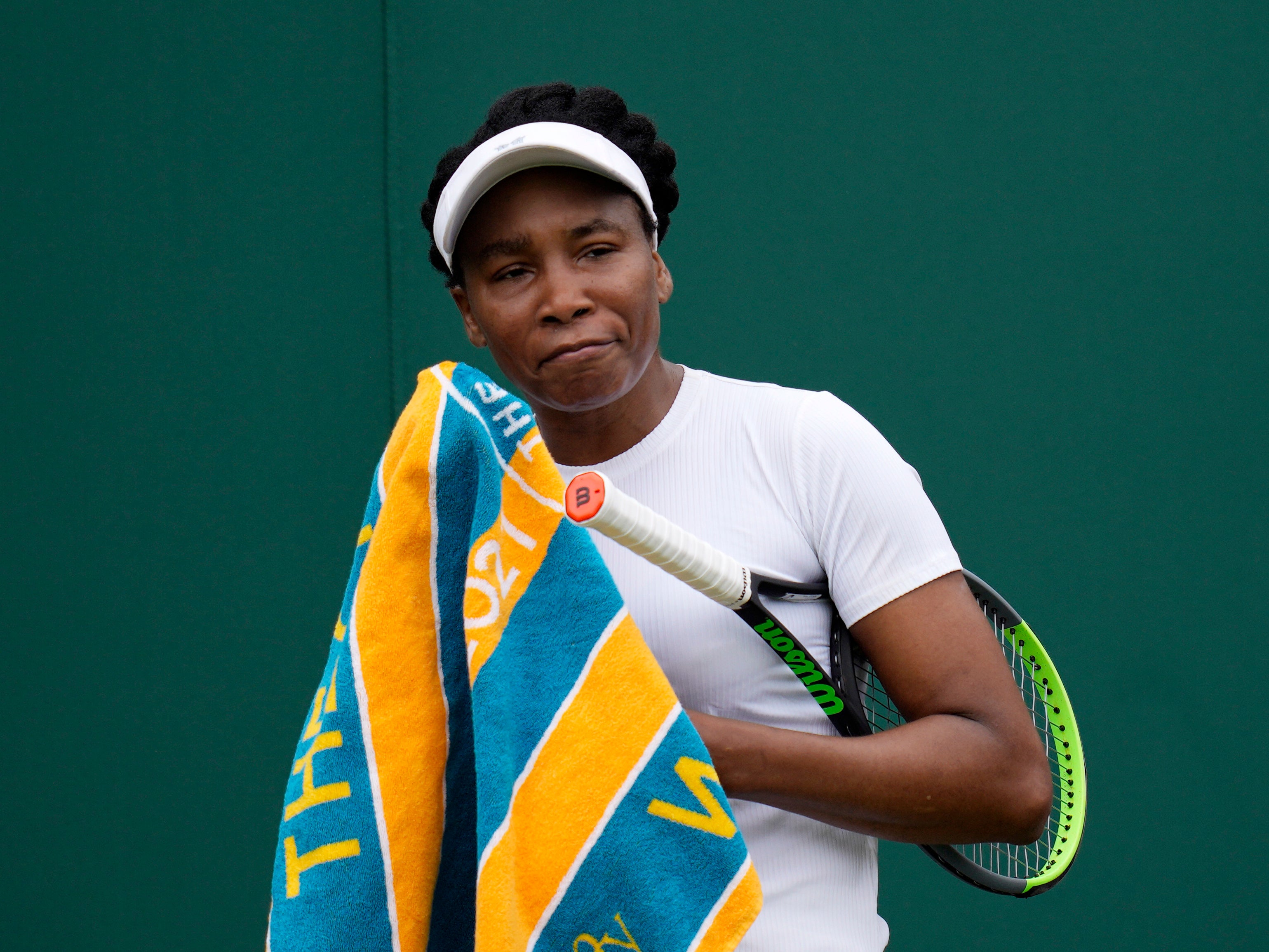 Venus Williams of the US uses a towel during the women's singles first round match against Romania's Mihaela Buzarnescu on day two of the Wimbledon Tennis Championships in London