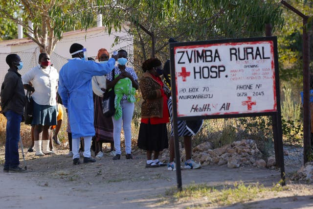 <p>Residents of Zvimba in rural Zimbabwe have their temperatures taken before seeking treatment at the local hospital </p>