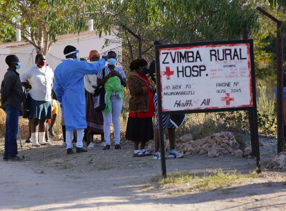 <p>Residents of Zvimba in rural Zimbabwe have their temperatures taken before seeking treatment at the local hospital </p>