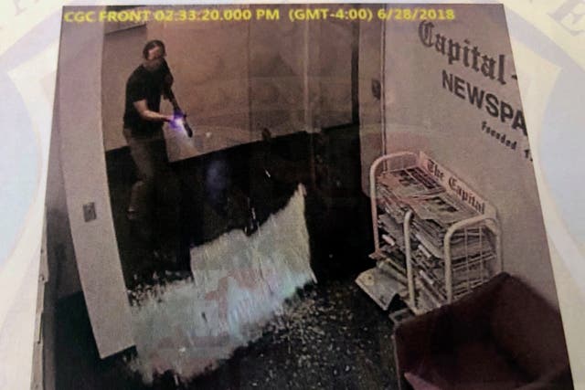 <p>This photograph of an image in court evidence made public on Tuesday, June 29, 2021 from surveillance video shows what authorities say is Jarrod Ramos shooting open the door of the Capital Gazette office on June 28, 2018 in Annapolis, Md. </p>