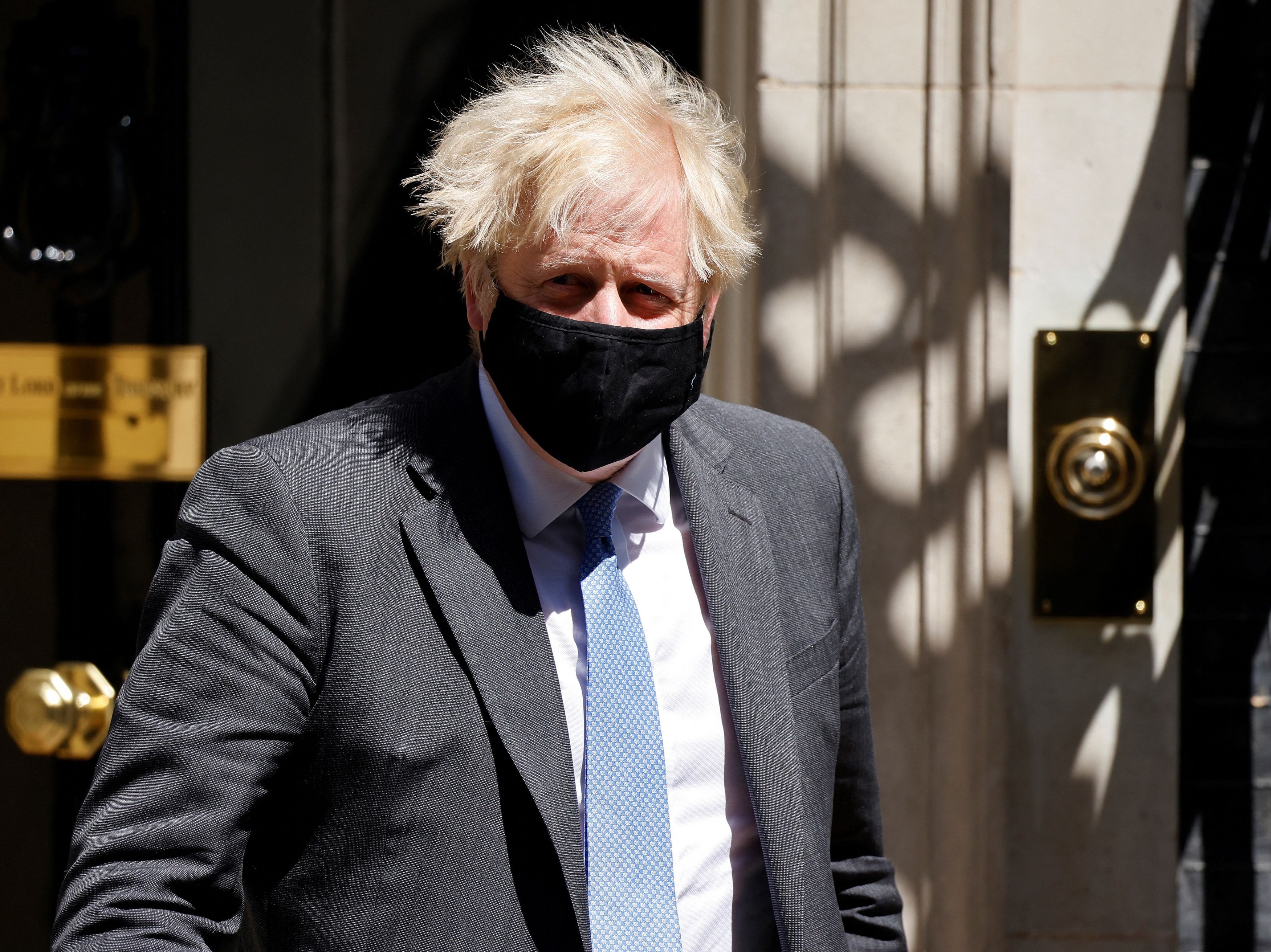 Johnson wears a mask as he exits No 10