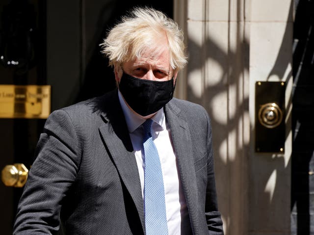 <p>Johnson wears a mask as he exits No 10</p>