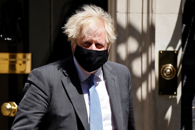 <p>Johnson wears a mask as he exits No 10</p>