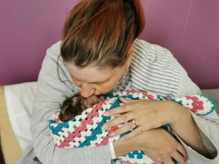 Sarah Andrews cradles her baby Wynter, who died during childbirth at Nottingham University Hospitals Trust