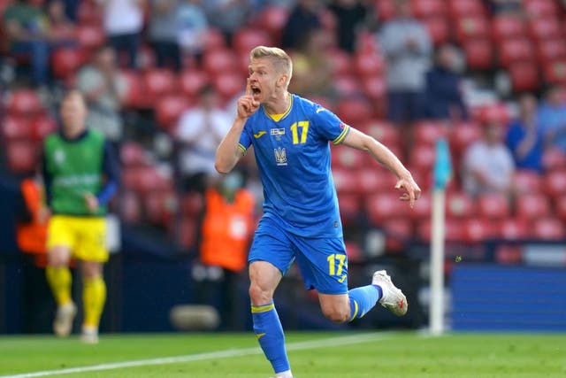 <p>Oleksandr Zinchenko celebrates scoring against Sweden</p>