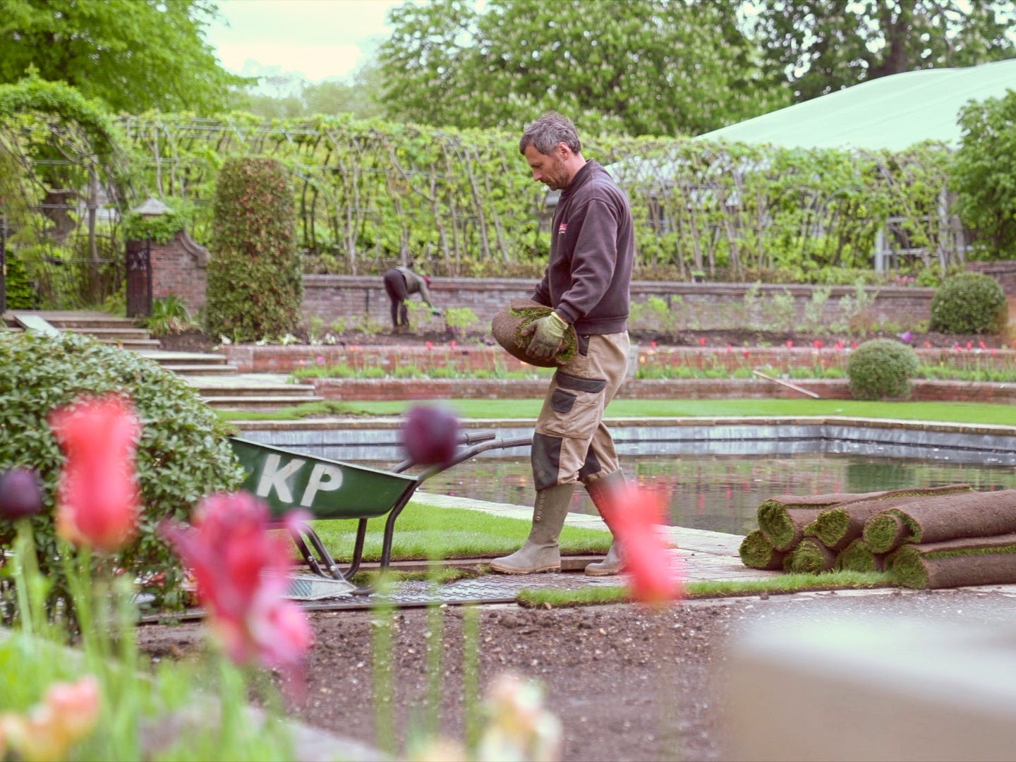 A gardener works on planting in the Sunken Garden in May 2021