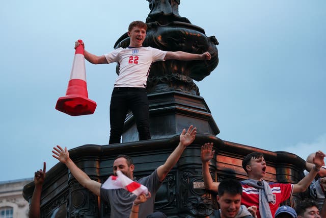 <p>Fans gather under the Statue of Eros in Piccadilly Circus, London, celebrating England’s victory </p>