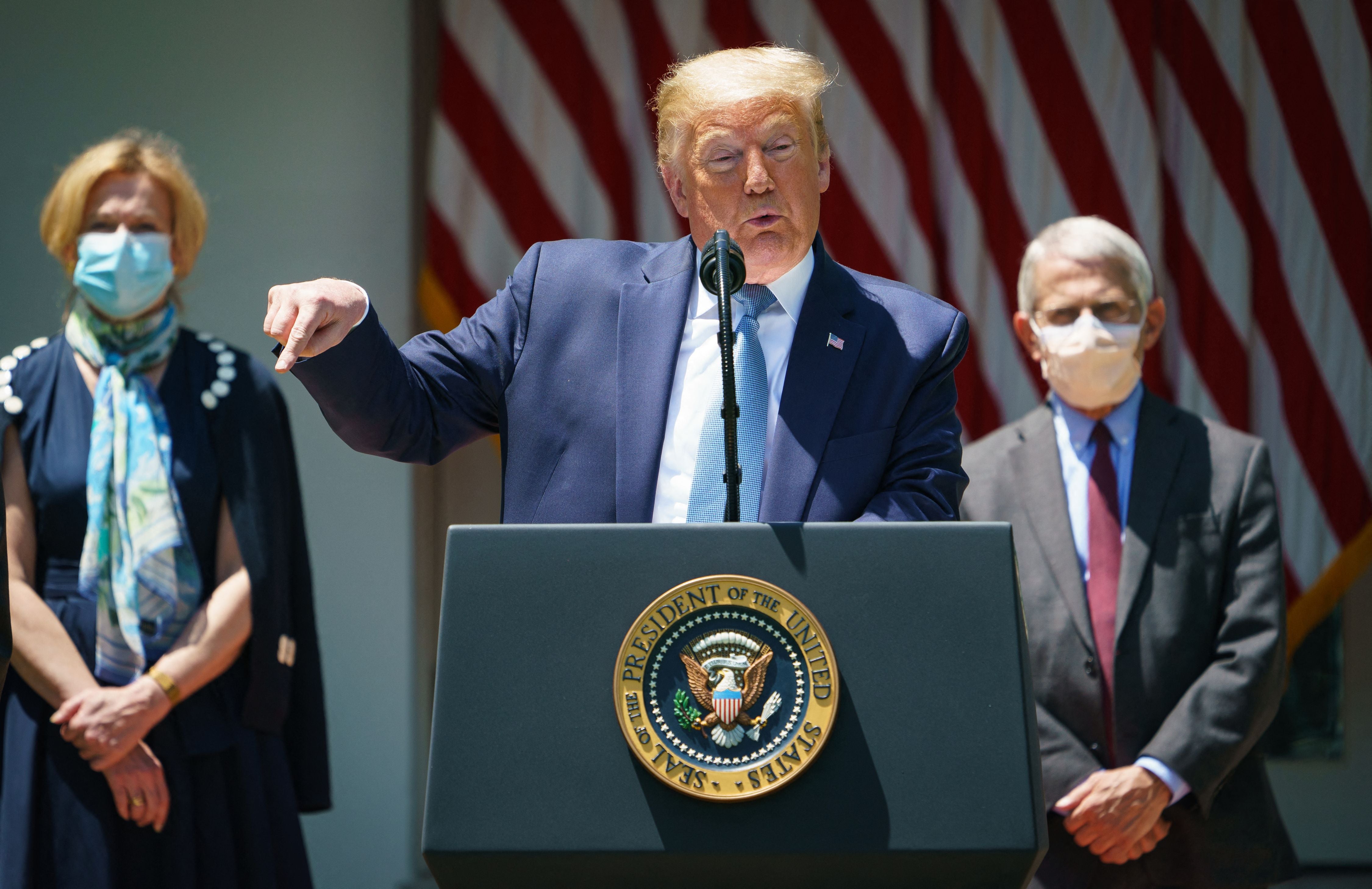 US President Donald Trump speaks on vaccine development in the Rose Garden of the White House in Washington, DC, flanked by White House Coronavirus Task Force Deborah Birx and Director of the National Institute of Allergy and Infectious Diseases Anthony Fauci