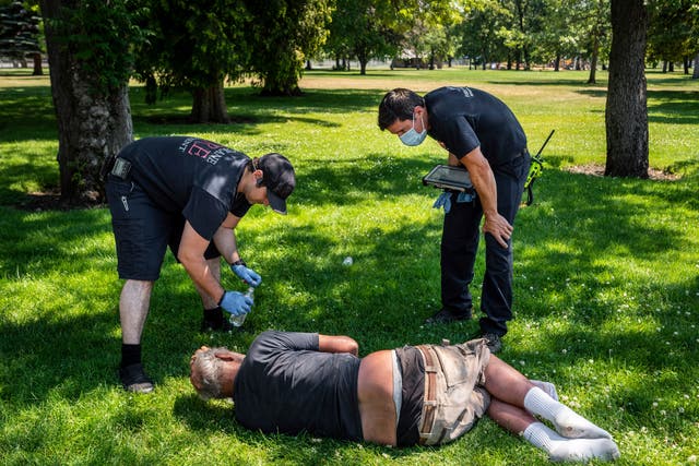 <p>EMTs in Spokane, Washington check on a resident amid extreme heat conditions</p>