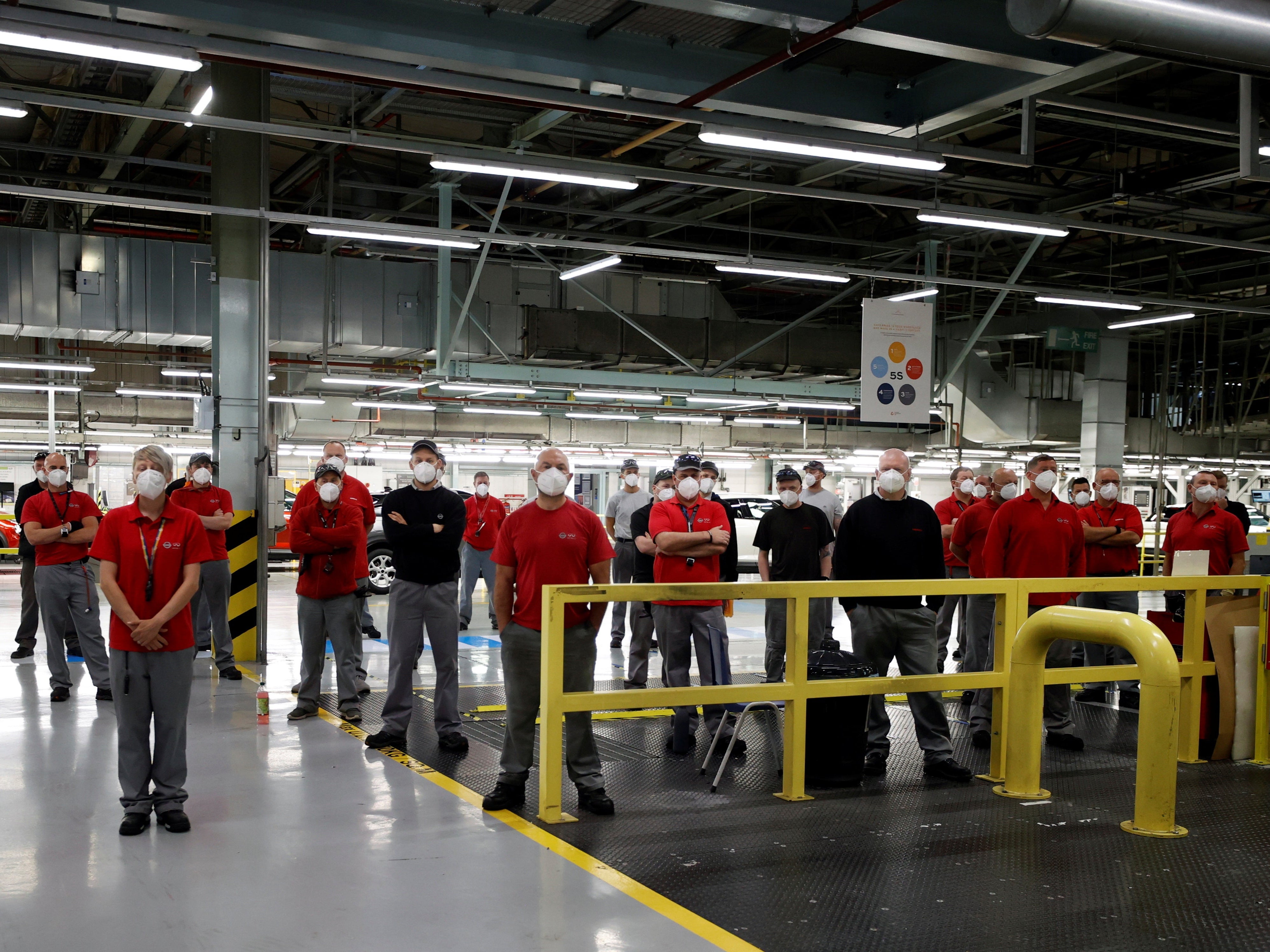 Nissan factory workers listen to the company’s announcement during a news conference at the Sunderland plant